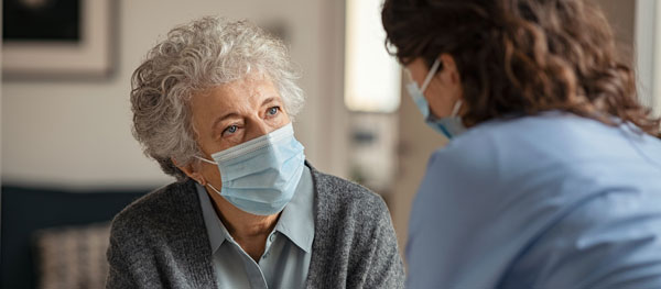 Nurse talking to an elderly woman